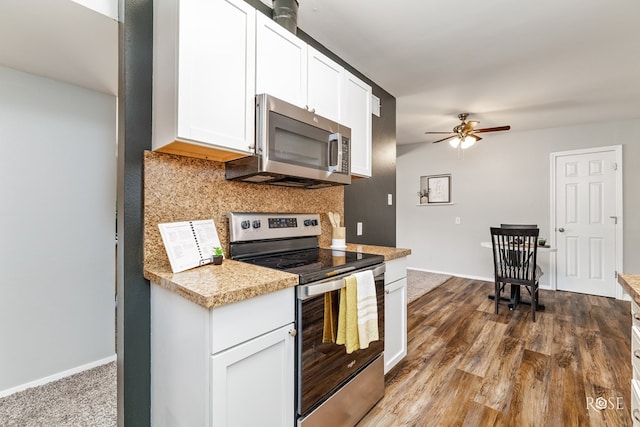kitchen featuring appliances with stainless steel finishes, light countertops, white cabinets, backsplash, and a ceiling fan