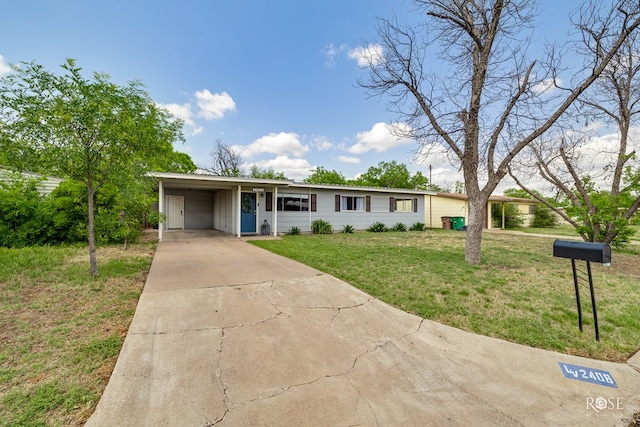 ranch-style house with concrete driveway, an attached carport, and a front lawn