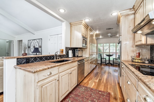 3110 Palo Duro Dr, San Angelo, TX 76904 - kitchen featuring wall chimney exhaust hood, appliances with stainless steel finishes, backsplash, wood finished floors, and ceiling fan