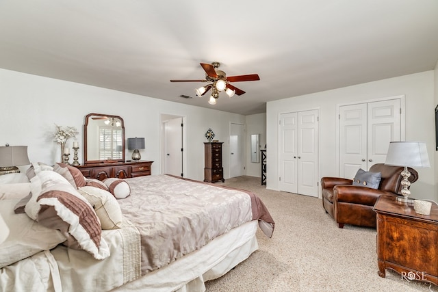 3110 Palo Duro Dr, San Angelo, TX 76904 - bedroom with two closets, light colored carpet, and a ceiling fan