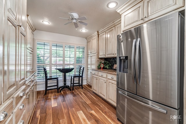 3110 Palo Duro Dr, San Angelo, TX 76904 - kitchen with stainless steel fridge, cream cabinets, ceiling fan, dark wood-style floors, and decorative backsplash