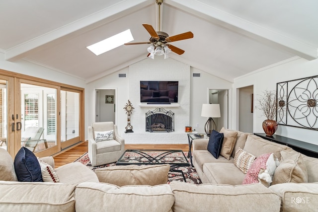 3110 Palo Duro Dr, San Angelo, TX 76904 - living area featuring wood finished floors, a skylight, a ceiling fan, and a fireplace