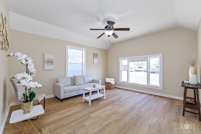 34 W 9th St, San Angelo, TX 76903 - living room featuring vaulted ceiling, a ceiling fan, baseboards, and light wood-style floors