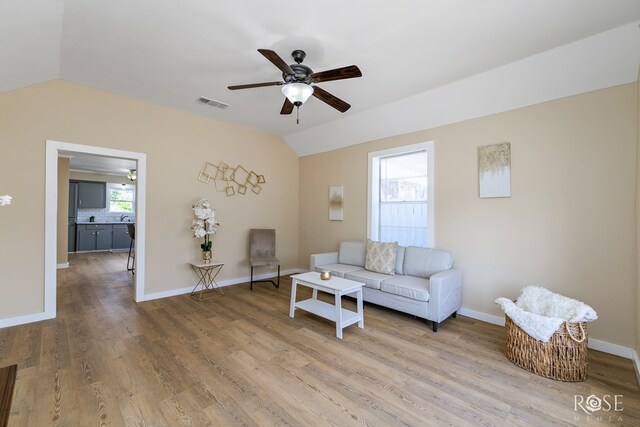 34 W 9th St, San Angelo, TX 76903 - living room with lofted ceiling, a ceiling fan, wood finished floors, and baseboards
