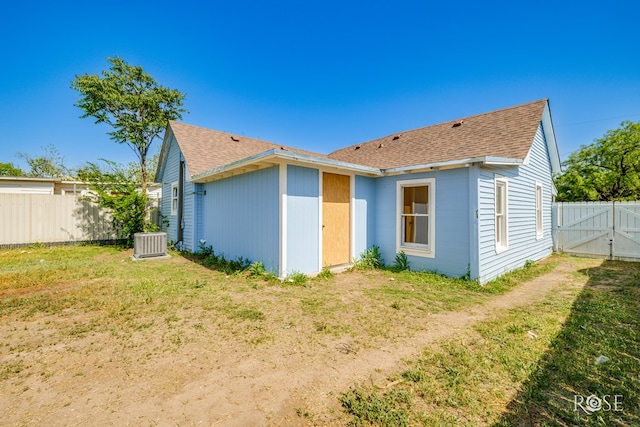 34 W 9th St, San Angelo, TX 76903 - back of property with a shingled roof, a gate, and cooling unit