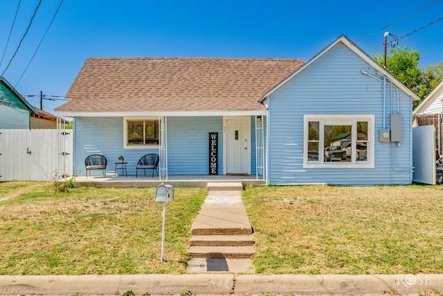 34 W 9th St, San Angelo, TX 76903 - view of front of home featuring a porch, a gate, and roof with shingles
