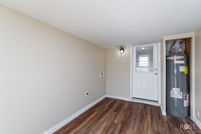 34 W 9th St, San Angelo, TX 76903 - unfurnished room with water heater, dark wood-style flooring, and baseboards
