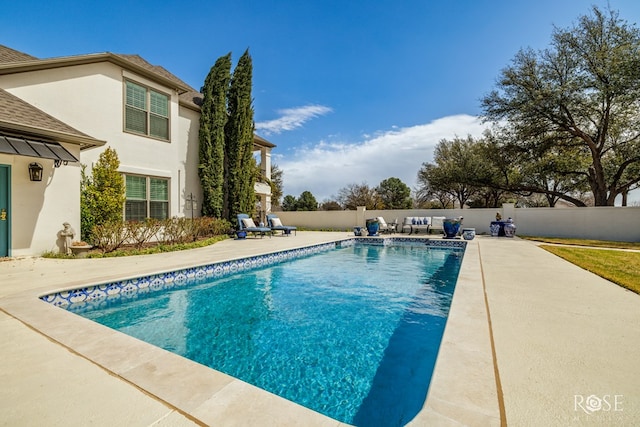 view of swimming pool featuring a patio area, a fenced in pool, and a fenced backyard