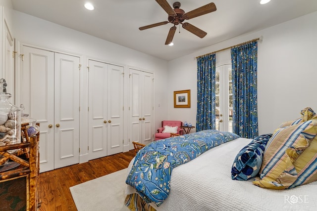 bedroom with access to exterior, recessed lighting, two closets, and wood finished floors