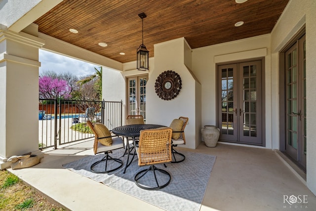 view of patio featuring a fenced in pool, french doors, and fence