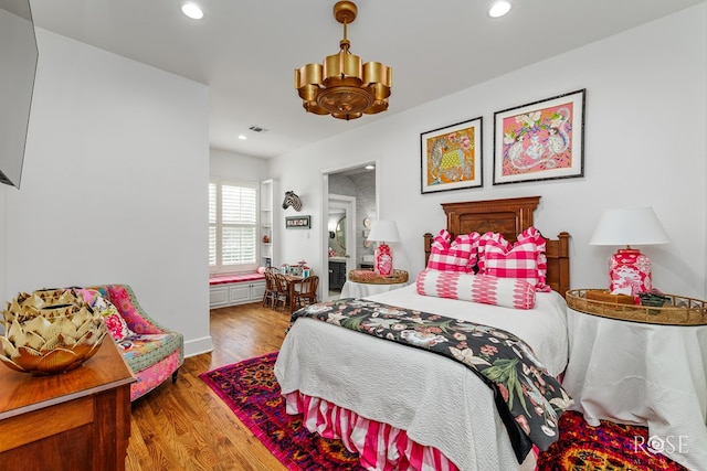 bedroom with recessed lighting, visible vents, and wood finished floors