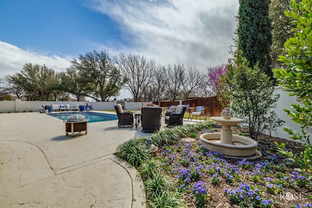 view of patio featuring outdoor dining area, a fenced in pool, and a fenced backyard