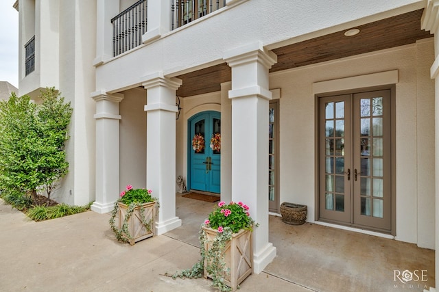 entrance to property with stucco siding and french doors