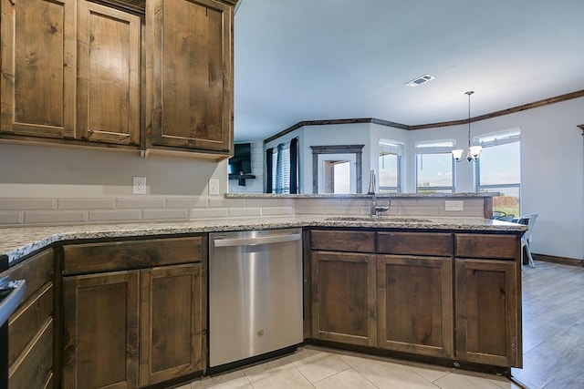 kitchen featuring sink, dishwasher, light stone counters, kitchen peninsula, and a chandelier