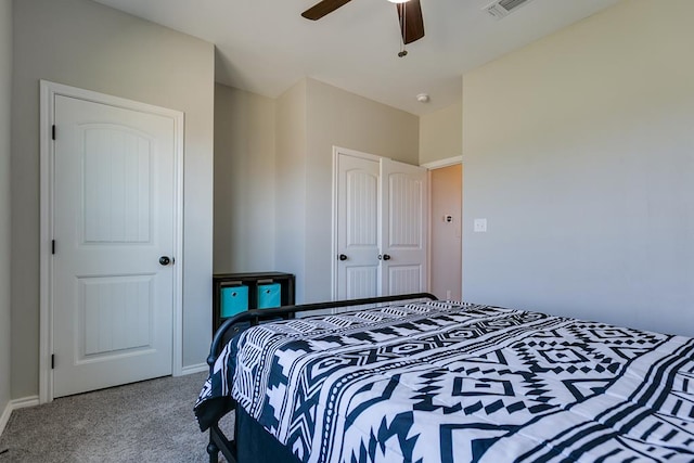 carpeted bedroom with a closet and ceiling fan