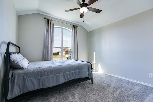 carpeted bedroom featuring lofted ceiling and ceiling fan