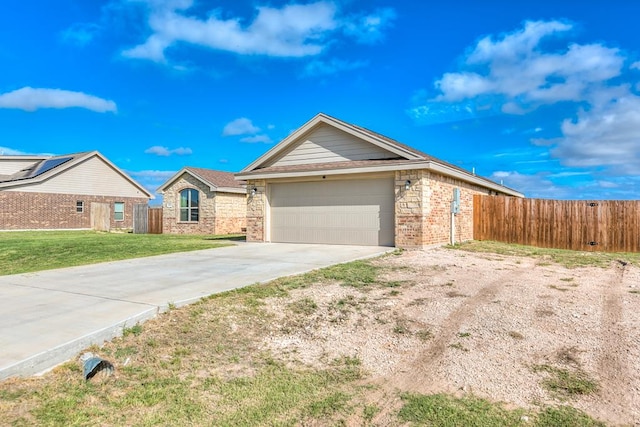 ranch-style home with a garage and a front yard