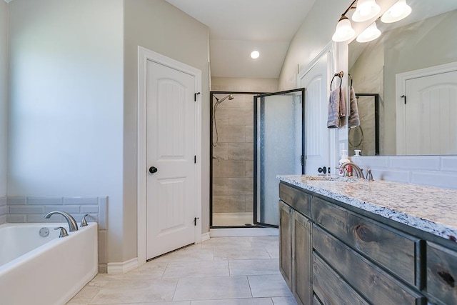 bathroom with tile patterned flooring, plus walk in shower, and vanity