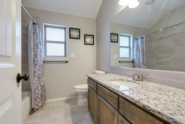 full bathroom featuring vanity, lofted ceiling, a healthy amount of sunlight, and toilet