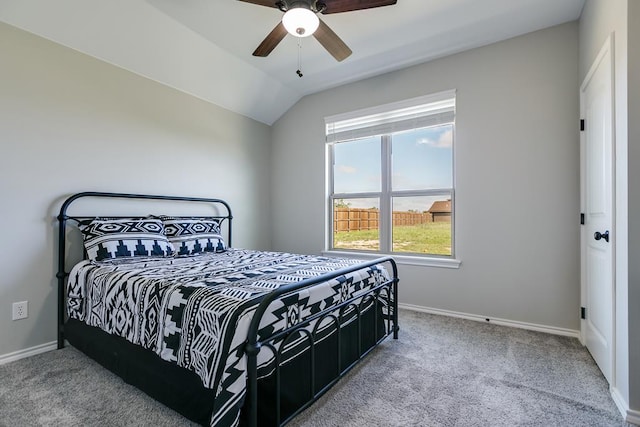 carpeted bedroom with vaulted ceiling and ceiling fan