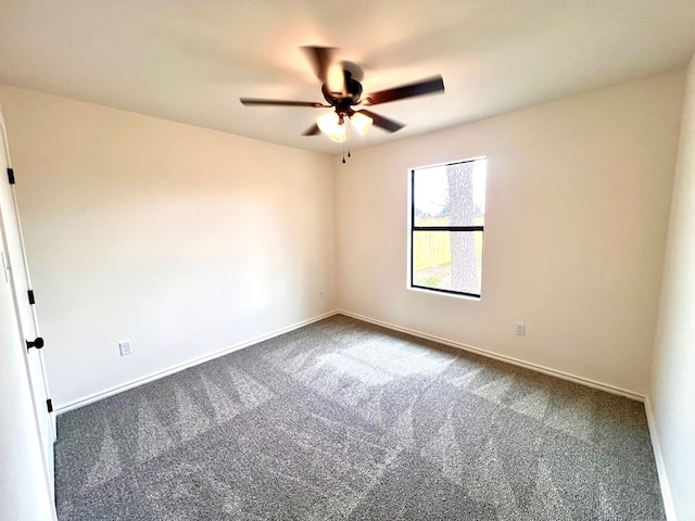 unfurnished room with ceiling fan, baseboards, and carpet