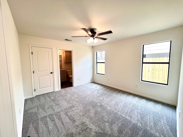 unfurnished bedroom featuring visible vents, a ceiling fan, ensuite bath, carpet, and baseboards