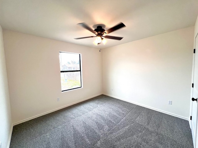 empty room with baseboards, a ceiling fan, and dark carpet