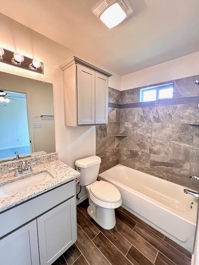 full bathroom with shower / bath combination, toilet, vanity, and wood finish floors