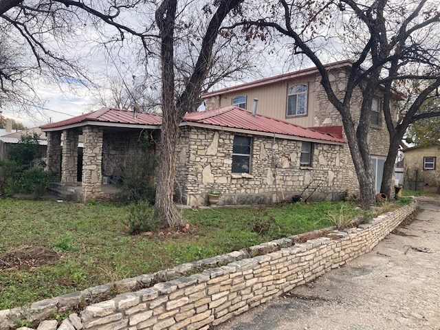 view of side of property with a lawn