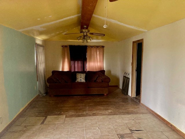 living room with ceiling fan and vaulted ceiling with beams