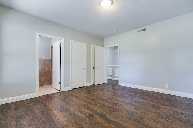 unfurnished bedroom featuring dark wood-type flooring