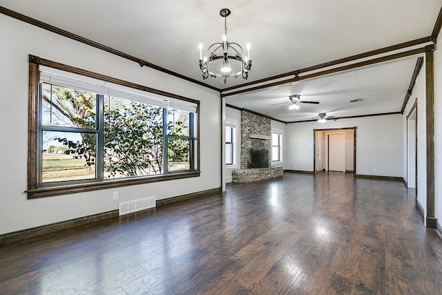 unfurnished living room with crown molding, a stone fireplace, ceiling fan with notable chandelier, and dark hardwood / wood-style flooring