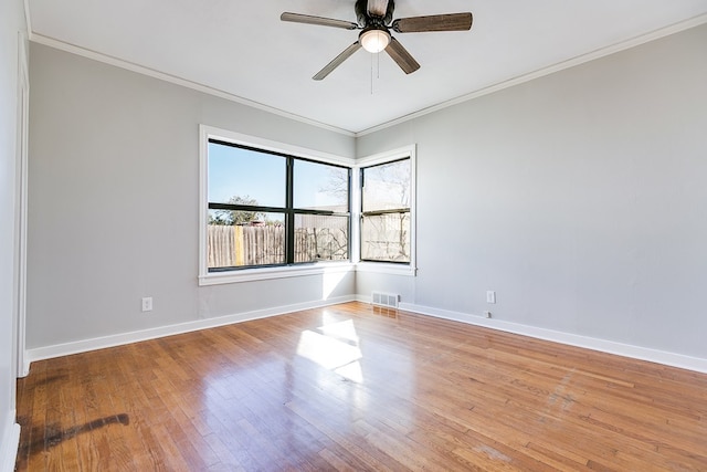 unfurnished room with crown molding, ceiling fan, and light hardwood / wood-style flooring