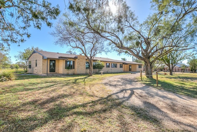 back of property featuring a lawn