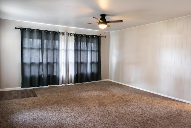 carpeted spare room featuring a ceiling fan