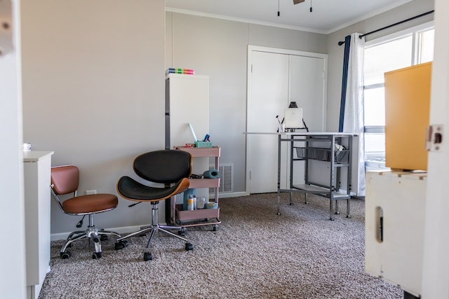 interior space featuring crown molding, ceiling fan, and carpet