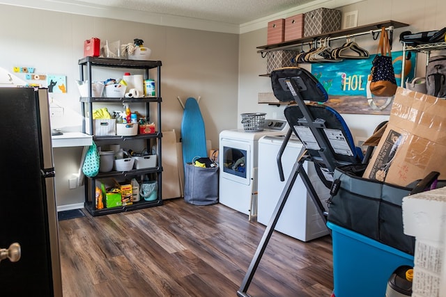 laundry area with ornamental molding, washing machine and dryer, dark hardwood / wood-style floors, and a textured ceiling