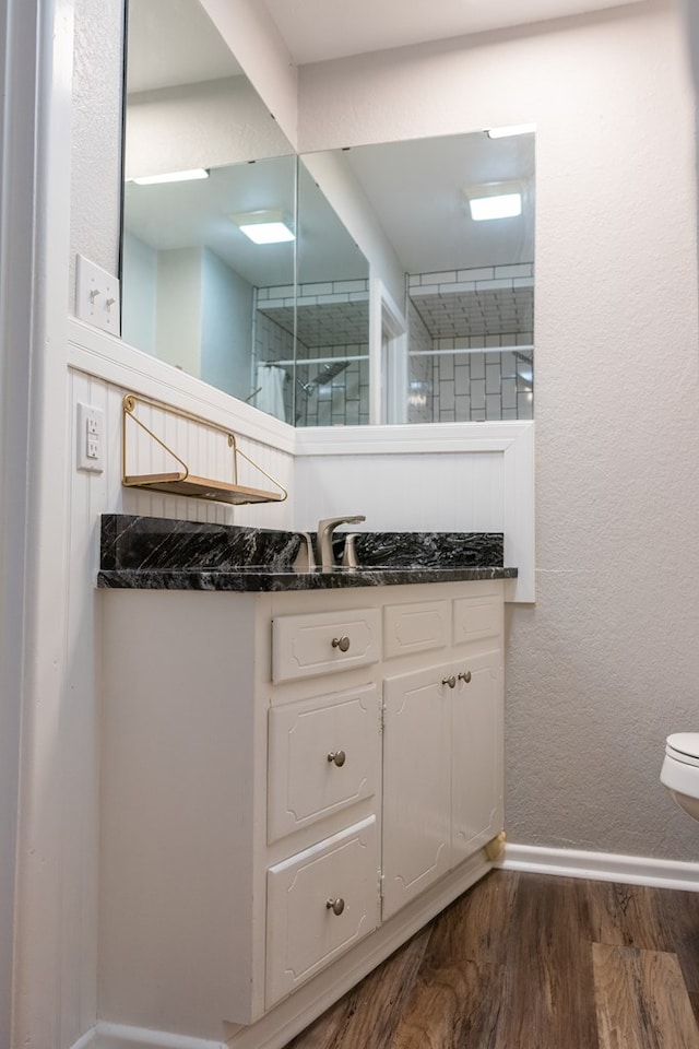 bathroom featuring vanity, wood-type flooring, and toilet