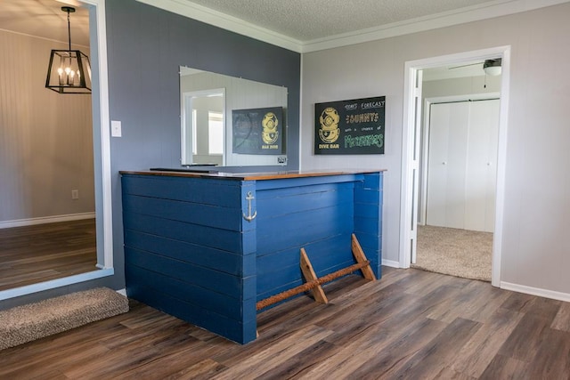 interior space with crown molding, baseboards, a chandelier, wood finished floors, and a textured ceiling