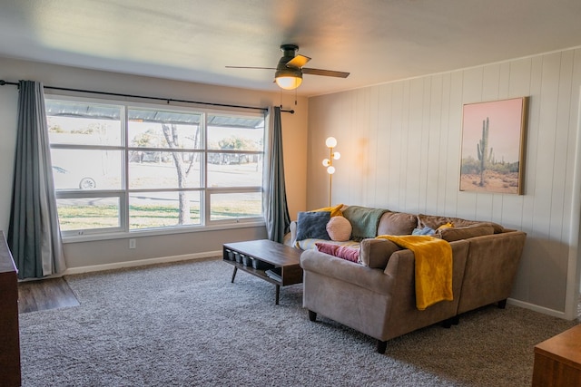 carpeted living room with ceiling fan