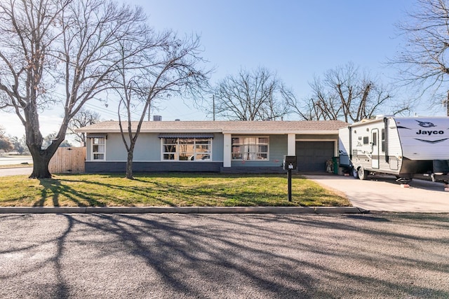 view of front of property with a front yard, a garage, driveway, and stucco siding