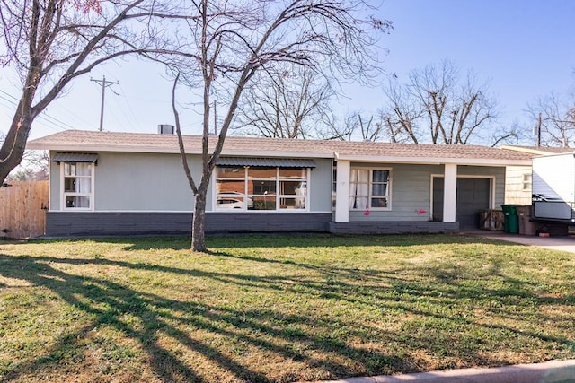 back of property with brick siding, fence, concrete driveway, a yard, and a garage