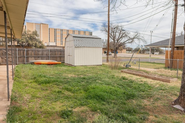 view of yard with a storage shed, fence, and an outdoor structure