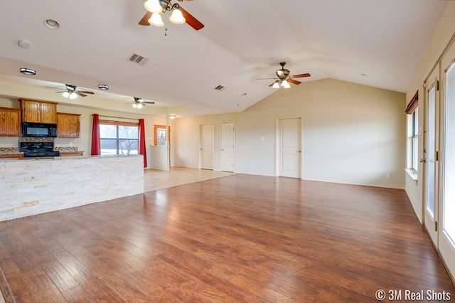 unfurnished living room with lofted ceiling, dark wood-type flooring, visible vents, and baseboards