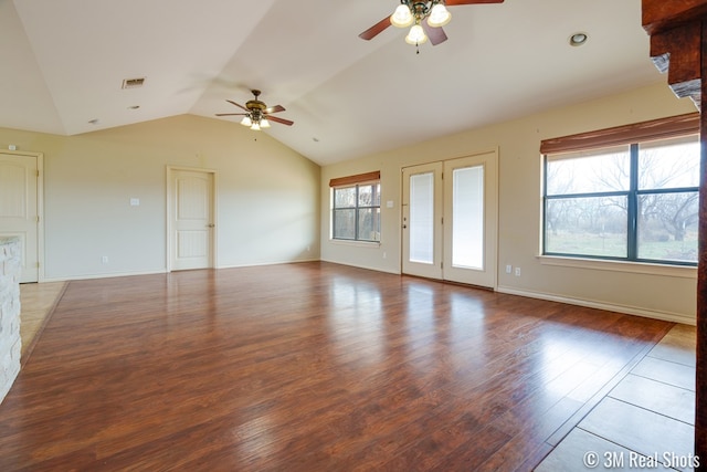 empty room featuring a ceiling fan, visible vents, vaulted ceiling, and wood finished floors