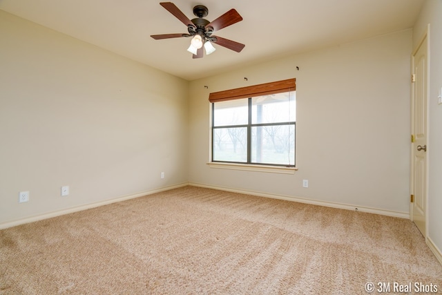 unfurnished room featuring baseboards, a ceiling fan, and light colored carpet