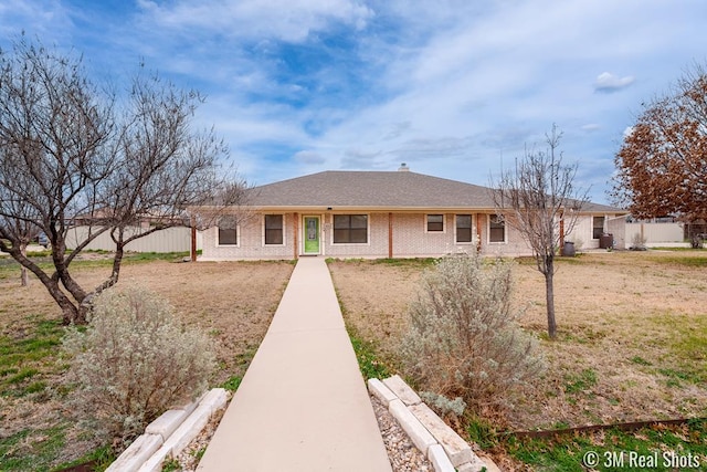 view of front of home with fence, a front lawn, and brick siding