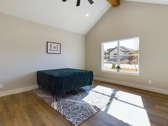 bedroom with beam ceiling, high vaulted ceiling, ceiling fan, and hardwood / wood-style flooring