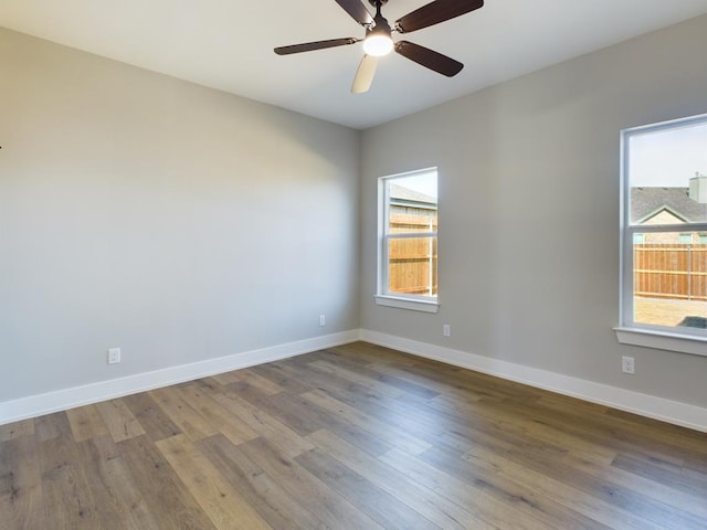 empty room with hardwood / wood-style floors and ceiling fan