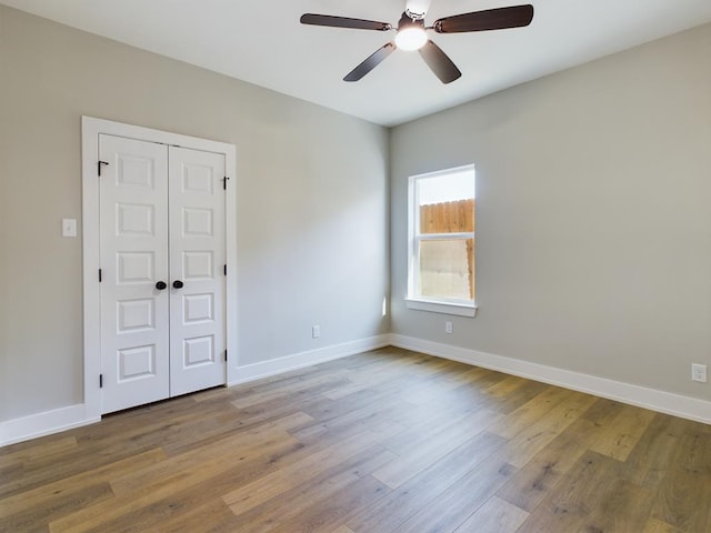 unfurnished room with ceiling fan and light wood-type flooring